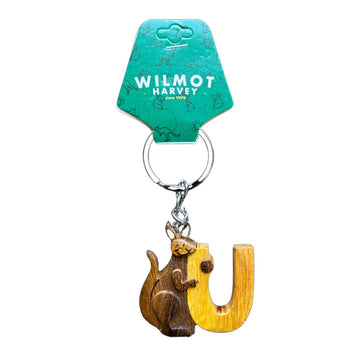 Keychain with wooden kangaroo and yellow 'U' letter on a green tag with 'Wilmot Harvey' branding.
