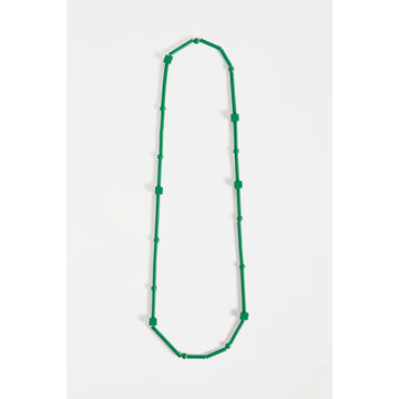 A green necklace made up of long and cube shaped beads.