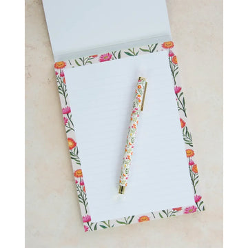 Writing pad with floral design and 'earth greetings' text on a white background.