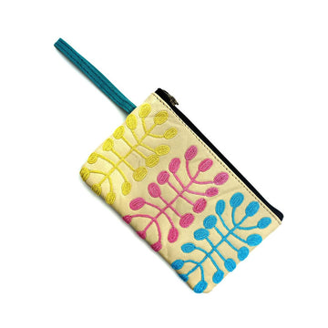 A leather coin purse embroidered with artwork of a yellow, pink and blue motif.