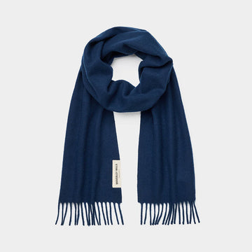 Navy blue scarf with fringes on a light gray background.