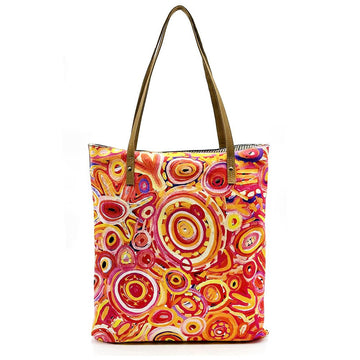 Front view of a tote bag printed with artwork by Cedric Varcoe in shades of red and yellow.