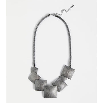 A silver mesh chain necklace with seven different sized squares on the front.