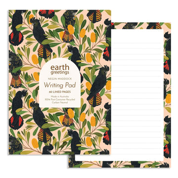 Writing pad with a design of black cockatoos and banksia flowers featuring the brand 'earth greetings'.
