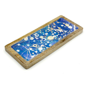 A wooden tray printed with artwork by Stephen Jupurrula Nelson on the inside.