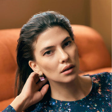 An image of a drop earring with a oval tigers eye stud with a pale pink square glass drop.