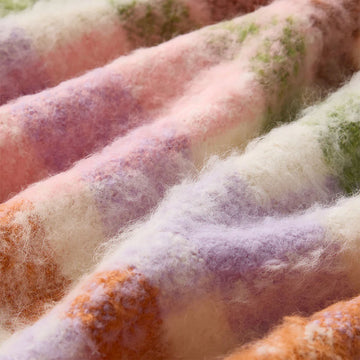 Multicolored scarf with a brand label on a white background.