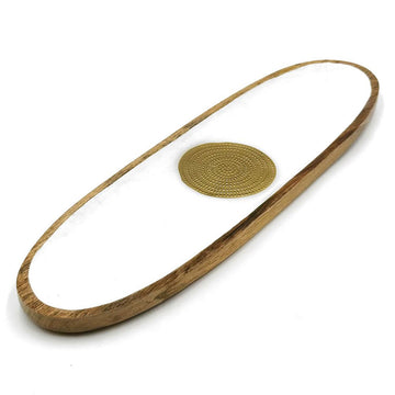 A long oval oblong shaped wooden tray painted white on the inside with a gold round medallion.
