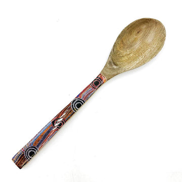 A wooden spoon printed with artwork by Mary Napangardi Brown on the handle.