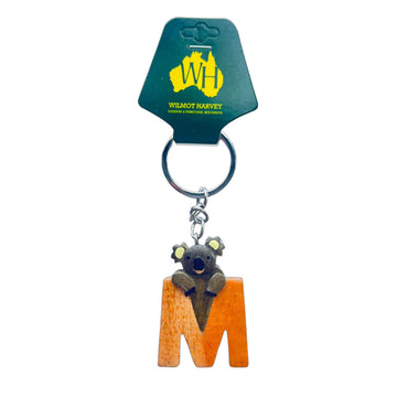 Keychain with a koala design on an 'M' shaped orange piece, attached to a green card with Wilmot Harvey branding.
