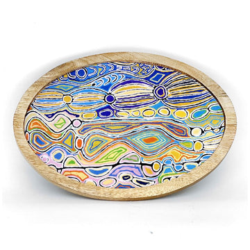 An oval shaped wooden tray printed with artwork by Judy Watson on the inside.