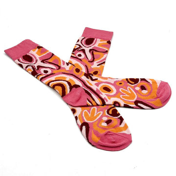 A pair of socks printed with artwork by Cedric Varcoe are overlapping each other.