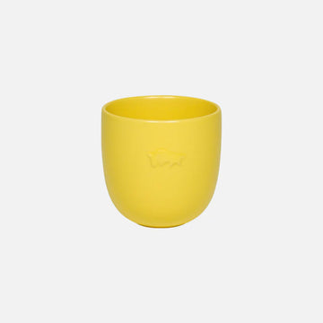 Yellow ceramic cup on a white background.