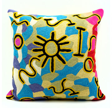 A square wool cushion printed with artwork by Willie Wilson.