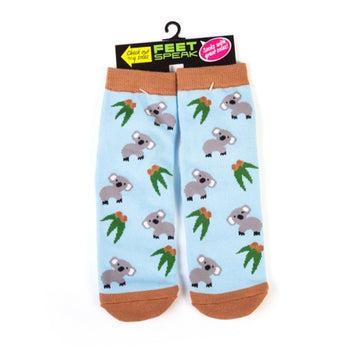 A pair of light blue socks printed with koalas hanging off a black tag with the text 'Feet Speak'.