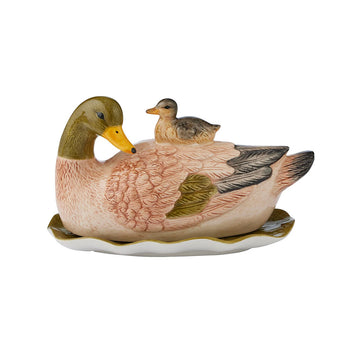A ceramic butter dish shaped like a duck with a baby duck on it's back.