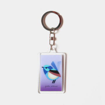 A rectangle keyring with a moving image of a fairy wren against a purple background.