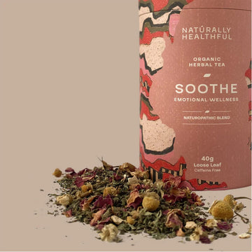 Pink cylindrical tea canister with abstract designs and text on a beige background.