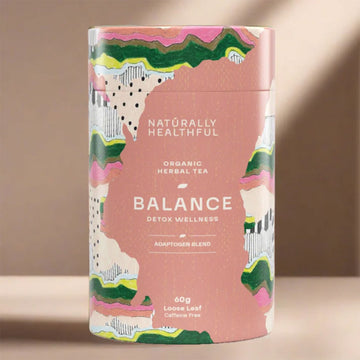 Tea canister labeled 'Naturally Healthful Balance' on a beige background.
