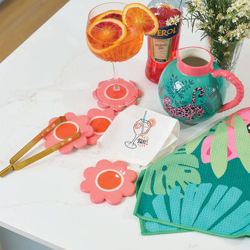 A set of four ceramic coasters shaped like flowers in pink.