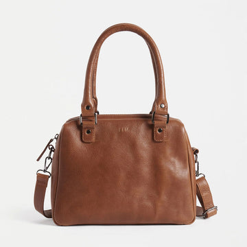 A tan leather bag with top handles and a long cross body strap.
