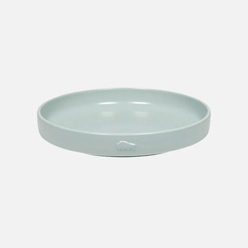 Light blue ceramic plate on a white background.