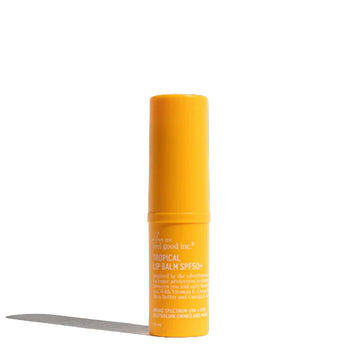 A yellow tube filled with lip balm and white text around the tube with product information.