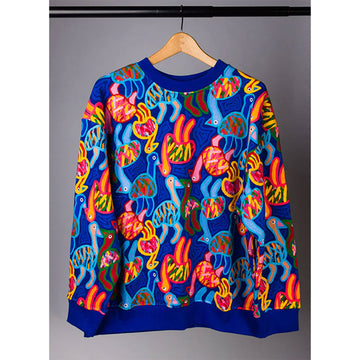 A jumper printed with illustrations of colourful emus on a blue base is hanging off a coat hanger.