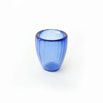 Blue glass beaker on a white background.