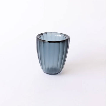 Blue glass beaker on a white background.