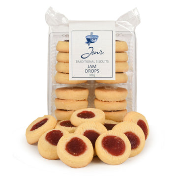 A packet of biscuits pictured standing up in clear packaging with a stack of biscuits covered with jam in front.