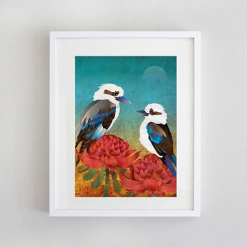 A framed print of an illustration of two kookaburras and two red waratah flowers.