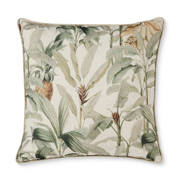 Decorative pillow with tropical leaf pattern on a white background.