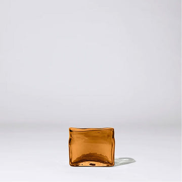 An irregular shaped rectangle vase in orange brown glass.
