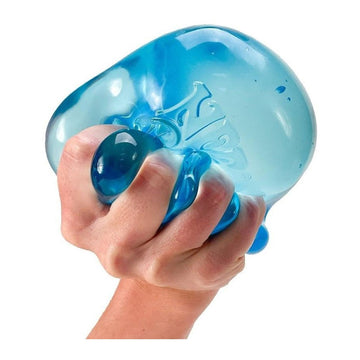 A squish stress ball shaped like an ice cube in an open box with the text 'Nee Doh Nice Berg' along the bottom.