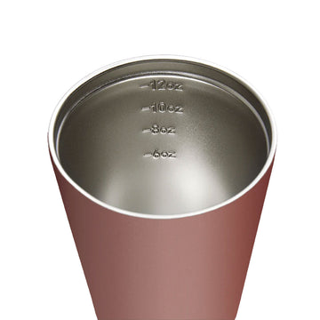 A travel mug in a brown tuscan colour with a black lid.
