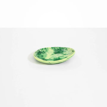 An oval shaped resin side plate in green.