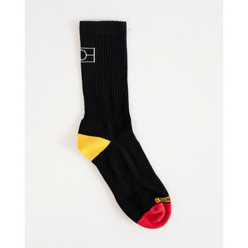 A black sock with a yellow heel and red toe and a white outline of the Aboriginal flag on the back.