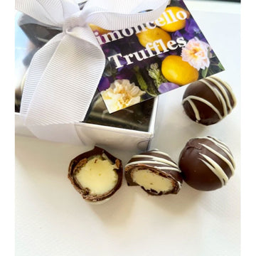 A box of four chocolate truffles pictured with a box and tag titled 'Limoncello Truffles' and a picture of four chocolate truffles next to the box with two split in half.