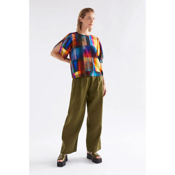 Colorful abstract patterned blouse on a white background.