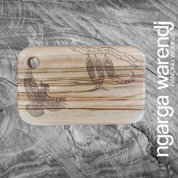 A wooden board with a hole in the top corner and a design of a cockatoo etched into it.