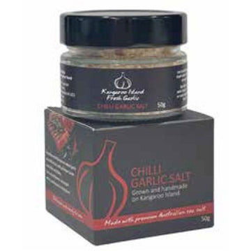 A small glass jar with chilli garlic salt inside sitting on top of its matching cube box.