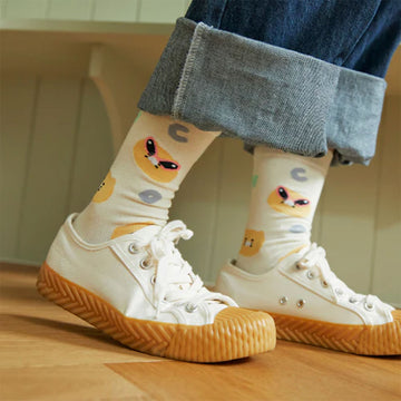 Pair of socks with cartoon character design on a white background.
