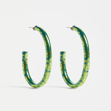 Green and blue speckled hoop earrings on a white background.