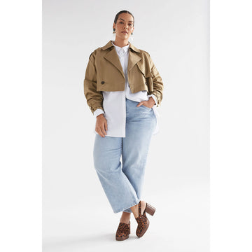 A cropped trench jacket in a sandstone colour.