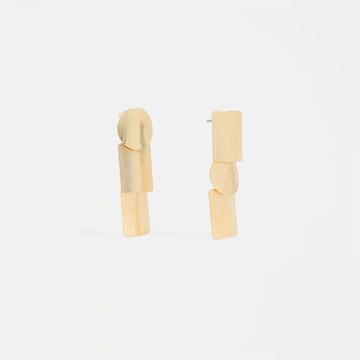 Pair of gold drop earrings made up of three slightly overlapping shapes on a white background.