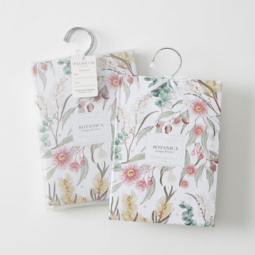 Two packets with floral prints on them and hanging hooks.