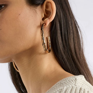 Pair of bronze hoop earrings with a speckled pattern on a white background