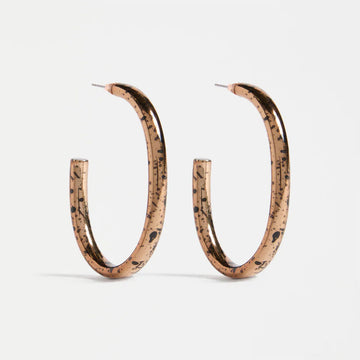 Pair of bronze hoop earrings with a speckled pattern on a white background