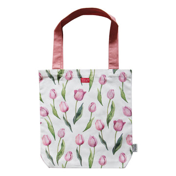 A tote bag with dark pink straps and illustrated with watercolour purple tulips.